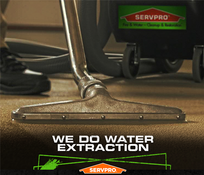 SERVPRO tech extracting water from water drenched carpet with the caption: WE DO WATER EXTRACTION