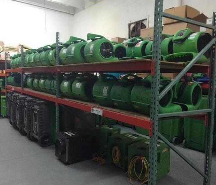 Shelves of our green equipment in a warehouse