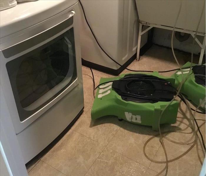 Laundry room with SERVPRO equipment in use